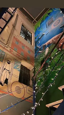 a building with a painting on the side of it at Itaca Hostel in Barcelona