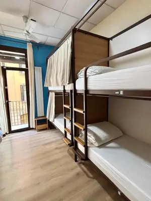 two bunk beds in a room with a window at Itaca Hostel in Barcelona