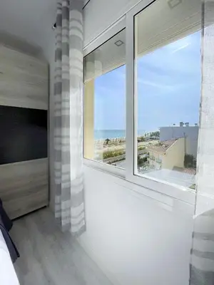a bedroom with a large window with a view of the ocean at fantasticas vistas a mar in Pineda de Mar