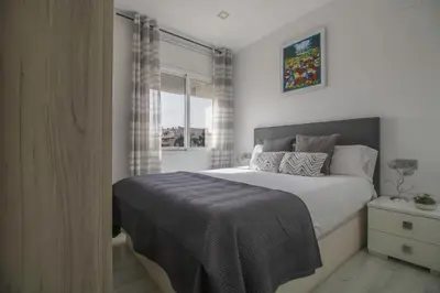 a bedroom with a large bed and a window at fantasticas vistas a mar in Pineda de Mar