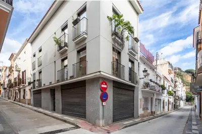 a building on a street with a no parking sign at Residential Tourist Apartments in Caldes d'Estrac