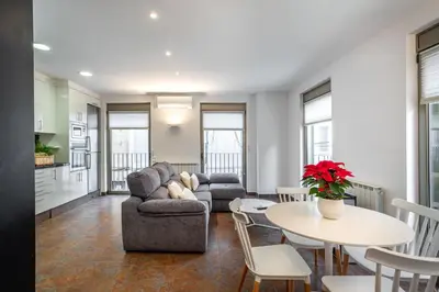 a living room with a couch and a table at Residential Tourist Apartments in Caldes d'Estrac