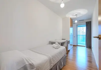 a white bedroom with a bed and a desk at Plaza Europa Fira Gran Via in Hospitalet de Llobregat