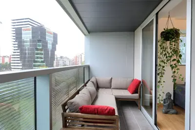 a living room with a couch on a balcony at Plaza Europa Fira Gran Via in Hospitalet de Llobregat