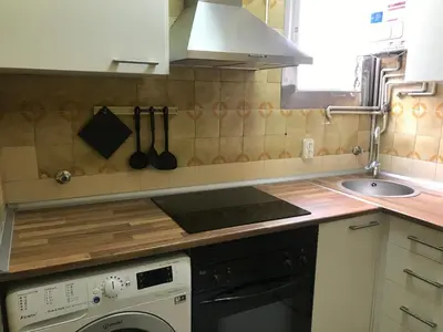 a kitchen with a stove and a sink and a dishwasher at Apartamento Joel in Barcelona