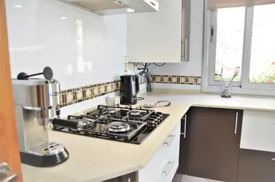a kitchen with a stove top oven in a kitchen at VILLA SOFIA CALELLA in Calella
