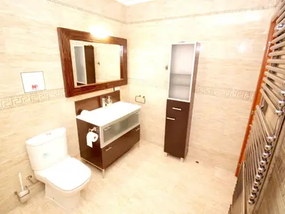 a bathroom with a toilet and a sink and a mirror at VILLA SOFIA CALELLA in Calella