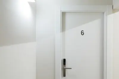 a white door in a room with a mirror at Hostal Oliveta in Barcelona