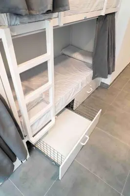 a room with white shelves in a room at Sea Hostel Barcelona in Barcelona