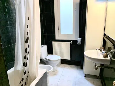 a bathroom with a toilet and a sink at Apartments Gaudi Barcelona in Barcelona