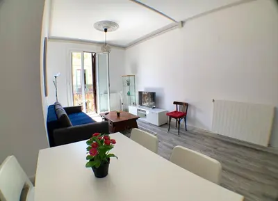 a living room with a table and a couch at Apartments Gaudi Barcelona in Barcelona