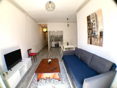 a living room with a blue couch and a table at Apartments Gaudi Barcelona in Barcelona