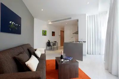 a living room with a couch and a table at Fisa Rentals Les Corts Apartments in Barcelona