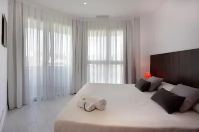 a bedroom with a large bed with two pillows on it at Fisa Rentals Les Corts Apartments in Barcelona
