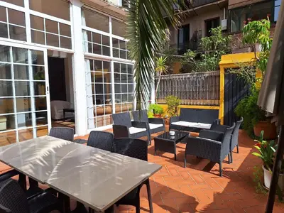 a patio with a table and chairs on a brick patio at Casa Consell Apartments in Barcelona