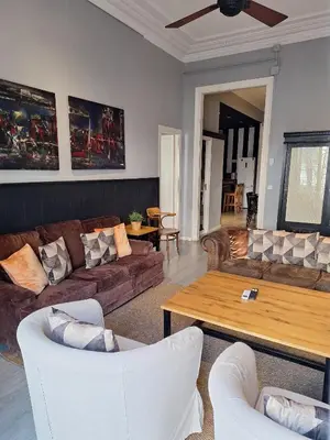 a living room with couches and a coffee table at Casa Consell Apartments in Barcelona