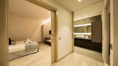 a bedroom with a bed and a sliding glass door at Fisa Rentals Ramblas Apartments in Barcelona