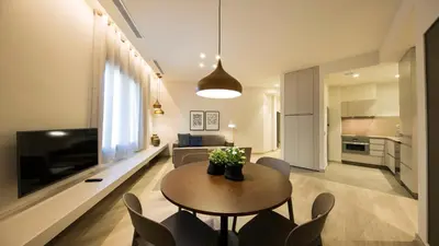 a living room with a table and chairs and a television at Fisa Rentals Ramblas Apartments in Barcelona