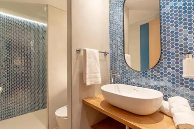 a bathroom with a sink and a shower at Serennia Cest Apartamentos Arc de Triomf in Barcelona