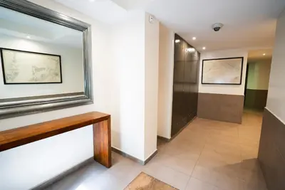 a hallway with a bench and a window at Serennia Cest Apartamentos Arc de Triomf in Barcelona
