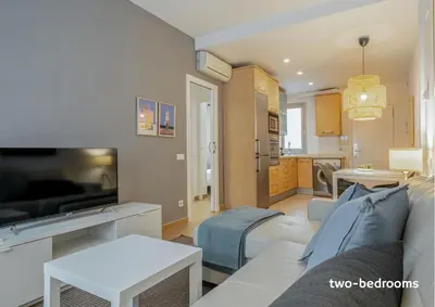 a living room with a couch and a tv at Inside Barcelona Apartments Salva in Barcelona
