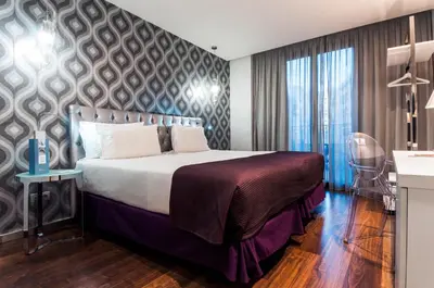 a hotel room with a bed and a desk at Ikonik Ramblas in Barcelona