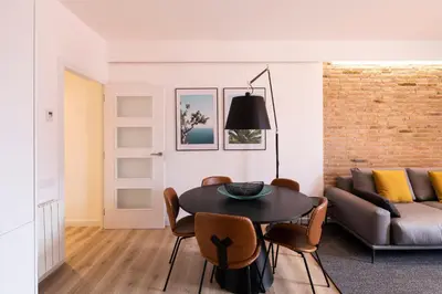 a living room with a table and a couch at Aspasios Sagrada Familia Apartments in Barcelona