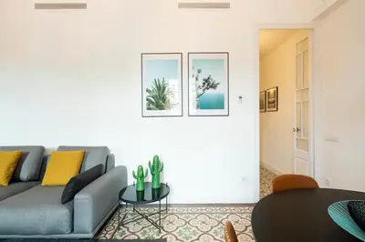 a living room with a couch and a table at Aspasios Sagrada Familia Apartments in Barcelona