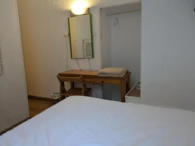 a bedroom with a bed and a desk with a mirror at Pension Casa De Barca in Barcelona