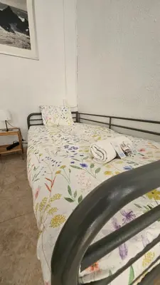a bedroom with a bed with a comforter on it at YOUTH HOSTEL - Central and Basic Drassanes in Barcelona