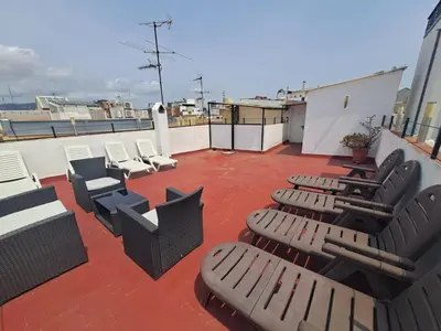 a patio with chairs anditures on a roof at YOUTH HOSTEL - Central and Basic Drassanes in Barcelona