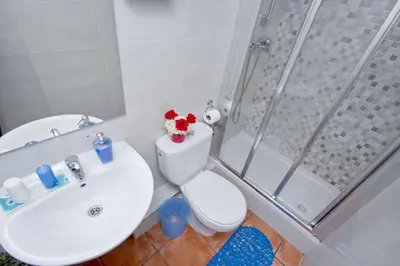 a bathroom with a sink and a toilet and a shower at Barcelona City Rooms Hostal in Barcelona