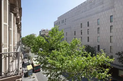 a tree in the middle of a street with buildings at Akira Flats Plaza Catalunya Centric apartments in Barcelona