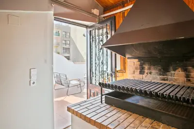 a kitchen with an outdoor grill on a balcony at Alcam Studio Alio3 in Barcelona