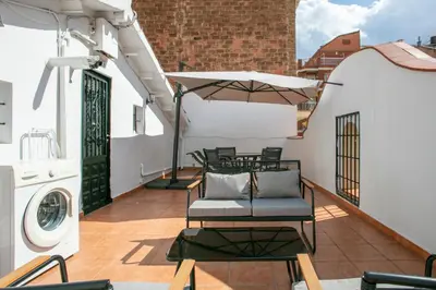 a balcony with chairs and a washing machine on a building at Alcam Studio Alio3 in Barcelona