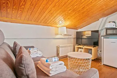 a living room with a couch and a table at Alcam Studio Alio3 in Barcelona