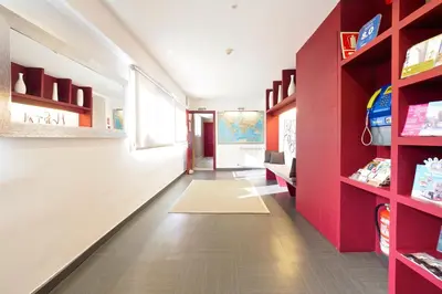 a room with red shelves and a hallway at Pensión Peiró in Barcelona