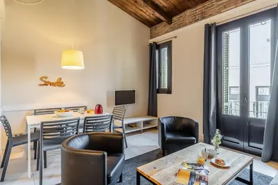 a living room with a table and chairs and a dining room at AB Poble Nou Venero in Barcelona