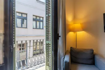 a window with a couch looking out at a balcony at AB Poble Nou Venero in Barcelona