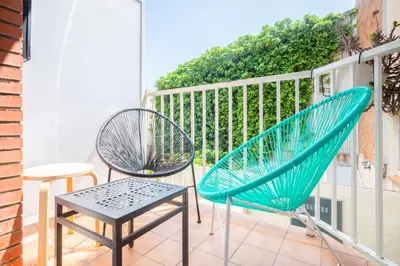 two chairs and a table on a balcony at Casa Barcelo Camp Nou Barcelona in Hospitalet de Llobregat