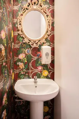 a bathroom with a sink and a mirror at Casa Barcelo Camp Nou Barcelona in Hospitalet de Llobregat
