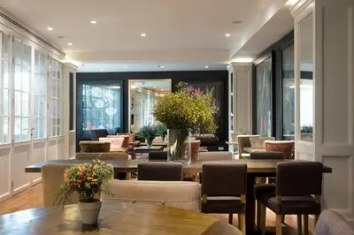 a restaurant with tables and chairs and windows at Ofelias Hotel 4Sup in Barcelona