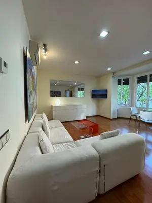 a living room with a large white couch at Hostal Madrazo in Barcelona