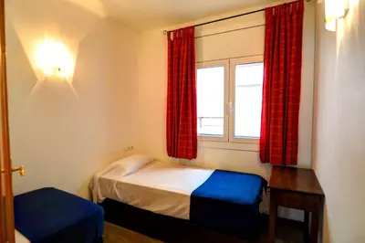 a small room with a bed and a window at Olivia Apartment by Hello Homes Sitges in Sitges