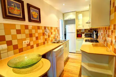 a kitchen with a melon sitting on a counter at Olivia Apartment by Hello Homes Sitges in Sitges