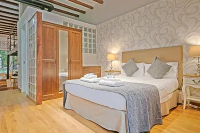 a bedroom with a large bed with towels on it at Alcam Loft Grassot in Barcelona
