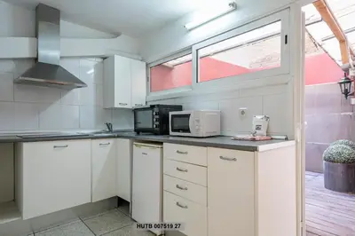 a kitchen with white cabinets and a microwave at Alcam Office up in Barcelona