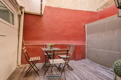 a table and two chairs on a patio at Alcam Office up in Barcelona