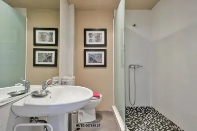 a bathroom with a sink and a toilet and a shower at Alcam Office up in Barcelona
