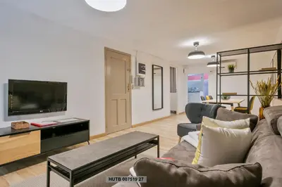 a living room with a couch and a flat screen tv at Alcam Office up in Barcelona